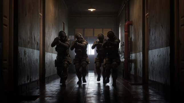 Soldiers walk down a corridor in formation.