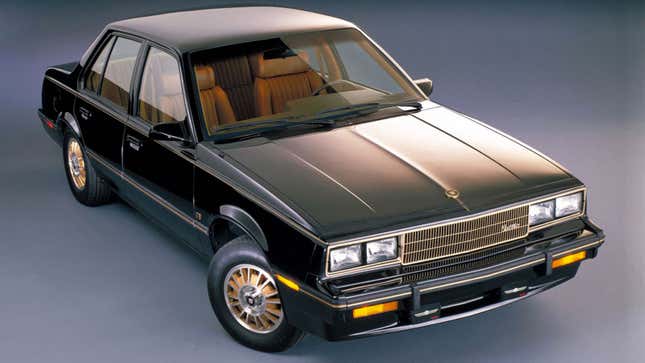 A photo of a black Cadillac sedan in a studio. 