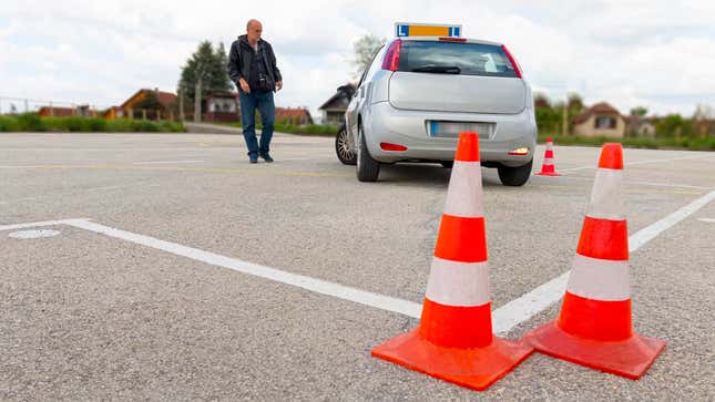 Driving instructor teaching student to reverse a car