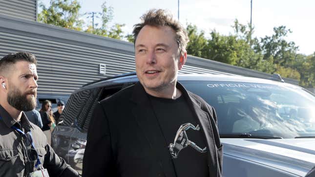 A photo of Elon Musk getting out of a car. 