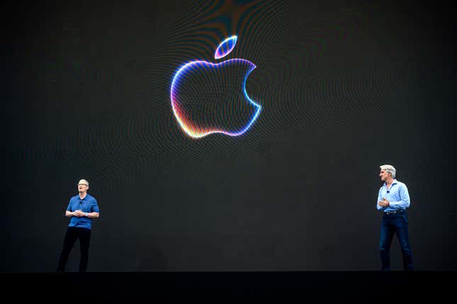 Tim Cook, chief executive officer of Apple Inc., left, and Craig Federighi, senior vice president of software engineering at Apple Inc., during the Apple Worldwide Developers Conference at Apple Park campus in Cupertino, California, US, on Monday, June 10, 2024.