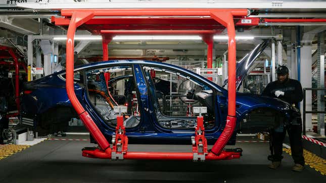 Paul Jacob works on the general assembly of the Tesla Model 3 at the Tesla factory in Fremont, California, on Thursday, July 26, 2018.