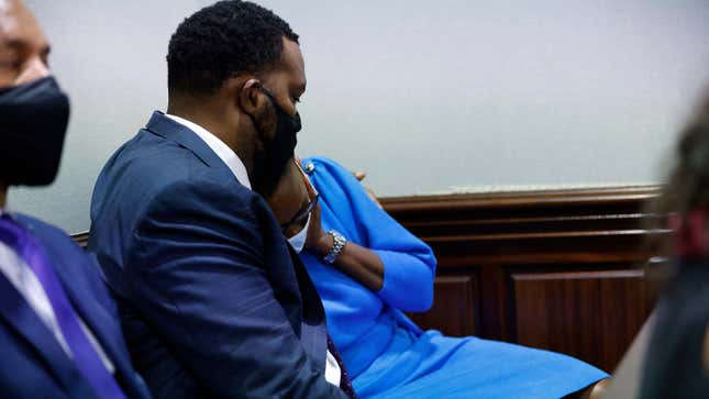 Ahmaud Arbery’s mother, Wanda Cooper, reacts next to her attorney Lee Merritt during the trial of William “Roddie” Bryan, Travis McMichael and Gregory McMichael, who are charged with the February 2020 death of 25-year-old Arbery, at the Gwynn County Superior Court, in Brunswick, Ga., Friday, Nov. 5, 2021. 