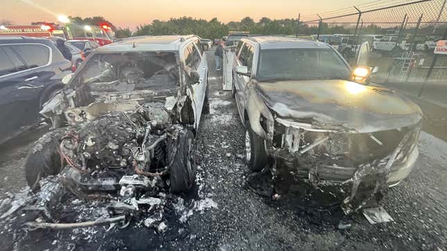 Two severely burned SUVs still parked side-by-side.