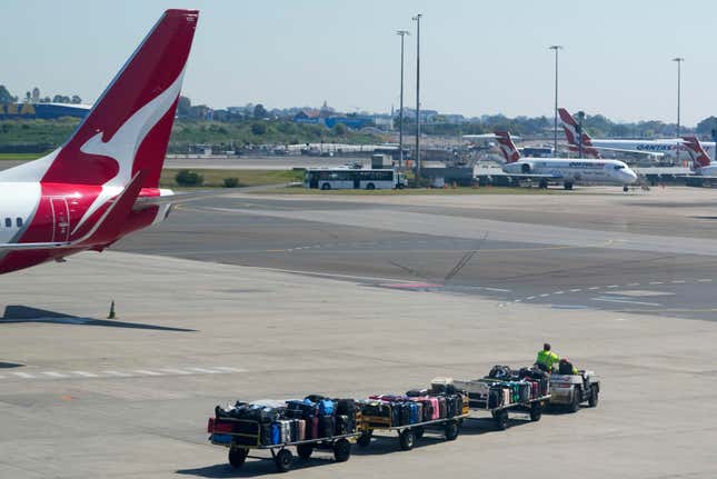 A baggage handler drives past a Qantas jet at Sydney&#39;s domestic terminal, Wednesday, Sept. 13, 2023. Qantas Airways lost its challenge to a court ruling on Wednesday that the Australian flag carrier had illegally fired 1,700 baggage handlers, cleaners and other ground staff at the height of pandemic travel disruptions. (AP Photo/Mark Baker)