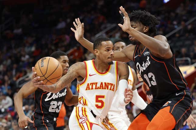 Nov 14, 2023; Detroit, Michigan, USA; Atlanta Hawks guard Dejounte Murray (5) dribbles defended by Detroit Pistons center James Wiseman (13) in the first half at Little Caesars Arena.