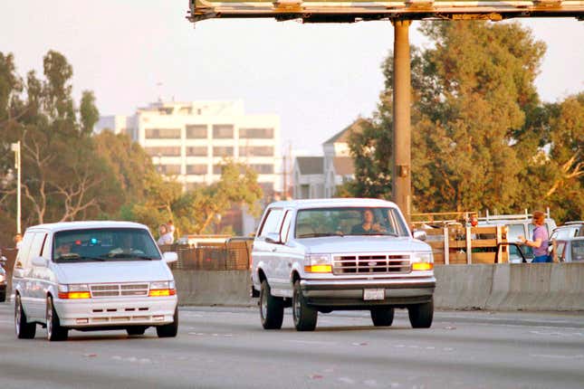 FILE - Al Cowlings, with O.J. Simpson hiding, drives a white Ford Bronco as they lead police on a two-county chase along the northbound 405 Freeway towards Simpson&#39;s home, June 17, 1994, in Los Angeles. Simpson, the decorated football superstar and Hollywood actor who was acquitted of charges he killed his former wife and her friend but later found liable in a separate civil trial, has died. He was 76. (AP Photo/Lois Bernstein, File)