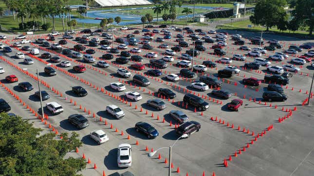 Cars line up at a drive through covid-19 testing site at Tropical Park on December 22, 2021 in Miami, Florida