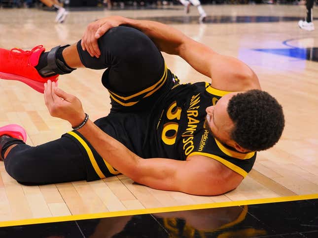 Nov 12, 2023; San Francisco, California, USA; Golden State Warriors guard Stephen Curry (30) holds his leg as he goes down on the floor during the fourth quarter against the Minnesota Timberwolves at Chase Center.