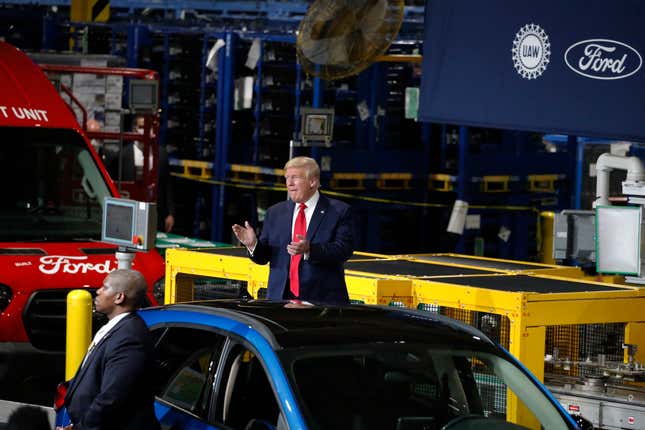 President Donald Trump visits and speaks with workers as he is