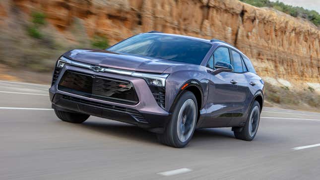 Front 3/4 view of the 2024 Chevrolet Blazer EV RS in Galaxy Gray Metallic driving down the road.