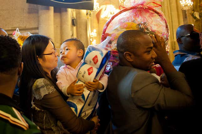 Members of the Sacred Heart Cathedral congregation donate groceries in Guangzhou. There are a growing number of interracial families in the city, according to Elochukwu Chikwendu, who was one of the first Nigerian traders to marry into a Chinese family.”We’re working to keep families together despite the cultural differences,” he said.