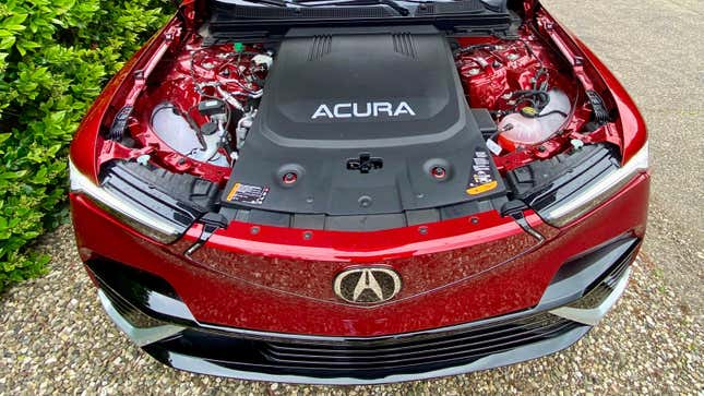 An under-hood shot of the ZDX showing a big plastic cover saying Acura