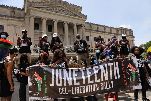 People participate in a march in Brooklyn for both Black Lives Matter and to commemorate the 155th anniversary of Juneteenth on June 19, 2020 in New York City. 