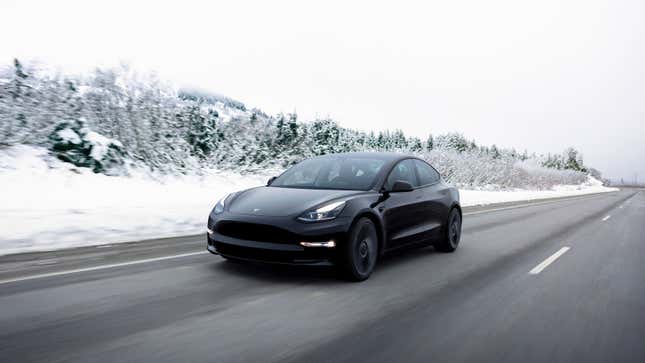 A photo of a black Tesla Model 3 sedan. 