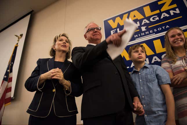 Rep. Tim Walz stands on stage at an election night party with his wife, Gwen Walz, son, Gus Walz, and daughter Hope Walz on August 14, 2018 in St Paul, Minnesota.