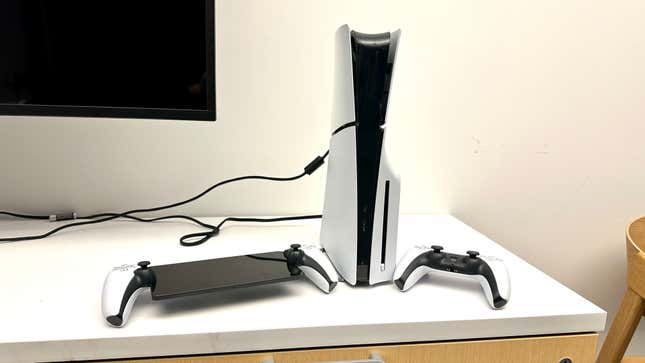 A playstation 5 console next to a Playstation Portal and DualSense controller.