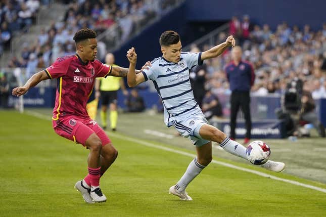 Nov 5, 2023; Kansas City, KS, USA; Sporting Kansas City forward Daniel Salloi (20) plays the ball defended by St. Louis City SC defender Akil Watts (20) in the first half of game two in a round one match of the 2023 MLS Cup Playoffs at Children&#39;s Mercy Park.