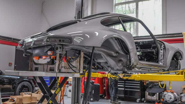 A photo of a Porsche in a workshop. 