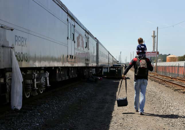 Ringling Bros. boss clown Sandor Eke carries his 2-year-old son, Michael, on his shoulders as he walks to the bus that will take them to the arena for a show, May 4.