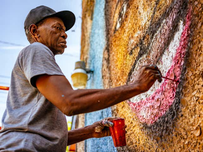 BRUNSWICK, GEORGIA / USA - May 14, 2020: Artist Marvin Weeks paints a mural of Ahmaud Arbery, who was shot to death in Glynn County, Georgia, on February 23, 2020.