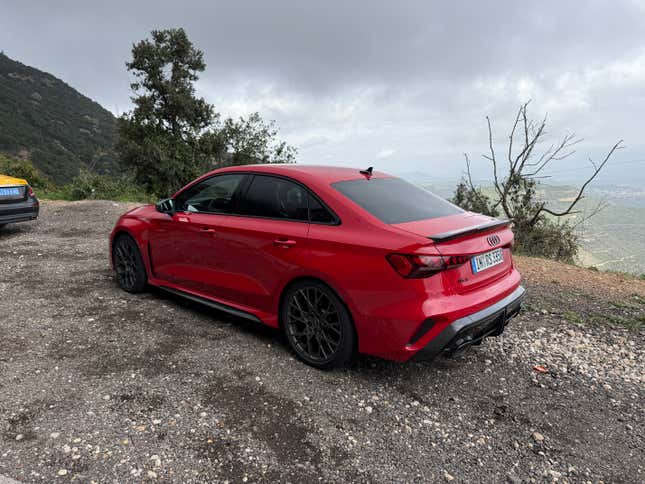 Rear 3/4 view of a red Audi RS3 sedan