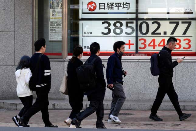 People walk past an electronic stock board showing Japan&#39;s Nikkei 225 index at a securities firm Friday, Feb. 16, 2024, in Tokyo. Shares advanced in Asia on Friday, with Tokyo&#39;s benchmark Nikkei 225 index trading near a record high, 34 years after it peaked and then plunged with the collapse of Japan&#39;s financial bubble. (AP Photo/Eugene Hoshiko)