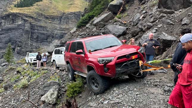 A line of SUVs stuck on a trail led by a red Toyota 4Runner