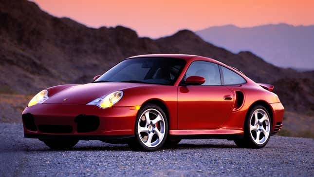 A photo of a red Porsche 996 at sunset. 