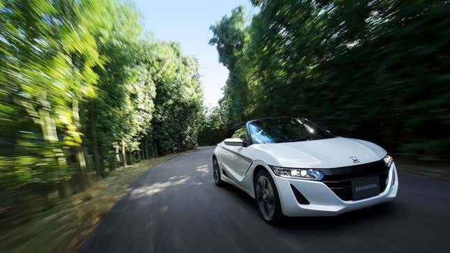 A photo of a white Honda S660 sports car. 