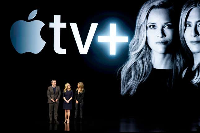 From left, Steve Carell, Reese Witherspoon and Jennifer Aniston speak at the Steve Jobs Theater during an event to announce new products Monday, March 25, 2019, in Cupertino, Calif.