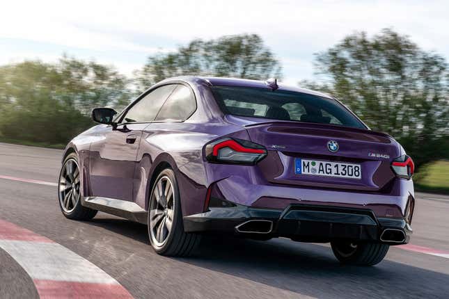 rear 3/4 view of a purple 2-series on a track