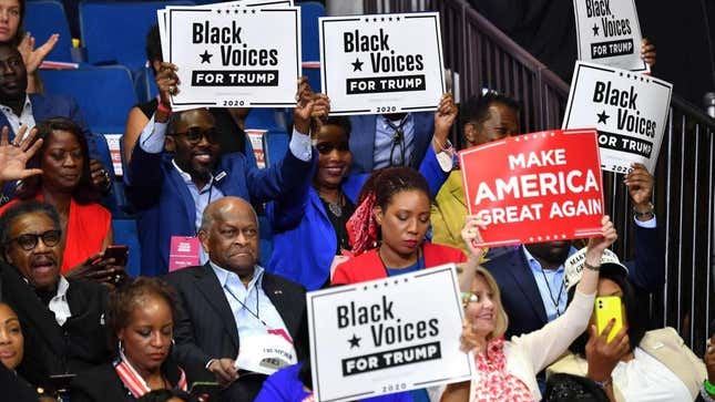 Herman Cain (C,L) and supporters of US President Donald Trump “Black Voices” listen to him speak during a campaign rally at the BOK Center on June 20, 2020 in Tulsa, Oklahoma.