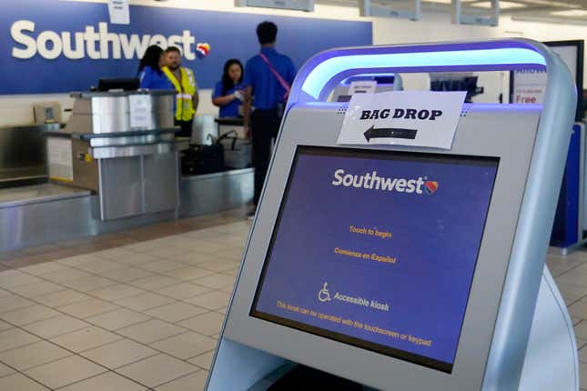 FILE - Employees stand by an empty Southwest Airlines ticket counter Tuesday, April 18, 2023, in Oklahoma City. Southwest Airlines reports earnings on Thursday, Oct. 26, 2023 (AP Photo/Sue Ogrocki, File)