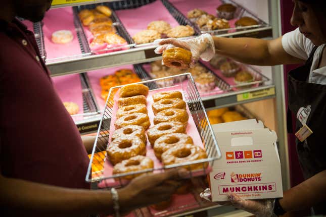 A Dunkin’ Donuts employee places a “croissant doughnut” in a box on November 3, 2014 in New York City.