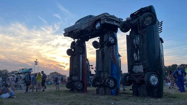 A photo of sunset over the Carhenge art installation. 