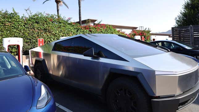 A tesla cybertruck backed into a supercharger space