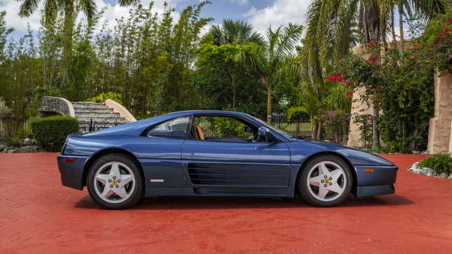 A photo of a vintage blue Ferrari. 