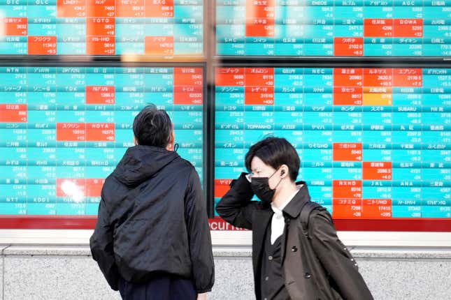 A person looks at an electronic stock board showing Japan&#39;s Nikkei 225 index at a securities firm Wednesday, Nov. 29, 2023, in Tokyo. (AP Photo/Eugene Hoshiko)