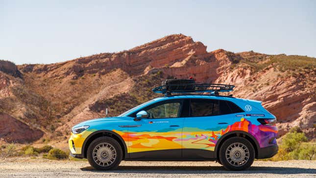 A VW ID.4 with a vibrant blue and orange livery parked in the desert 