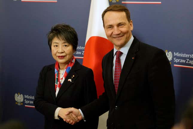 Japanese Foreign Minister Yoko Kamikawa, left, shakes hands with Polish Foreign Minister Radek Sikorski in Warsaw, Poland, on Monday Jan. 8, 2024. (AP Photo/Czarek Sokolowski)