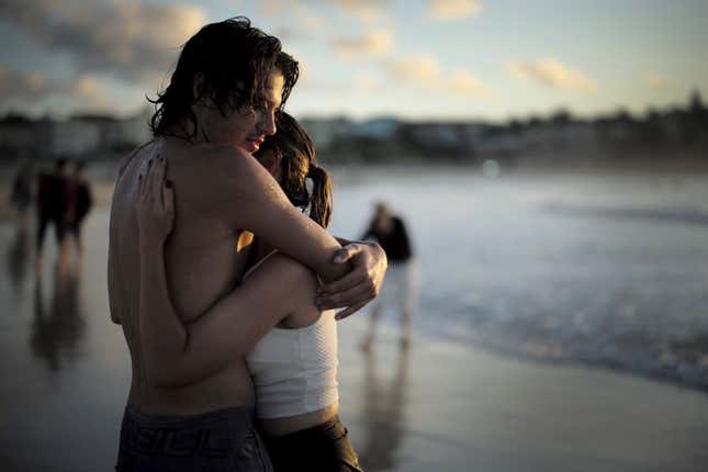 A couple embraces as they watch the first sunrise of the new year on Bondi Beach in Australia.