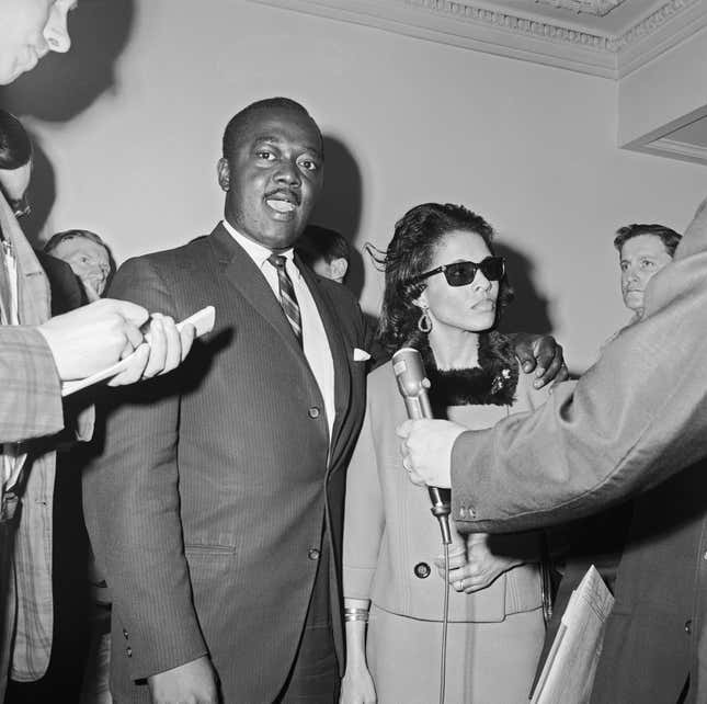 In this photo dated May 21, 1964, then 29-year-old Abraham Bolden was a suspended U.S. secret service agent. He walked with his wife before he was indicted on charges of offering to sell secret government documents to an underworld figure for $50,000. He was convicted in 1966. Today, President Joe Biden pardoned him.