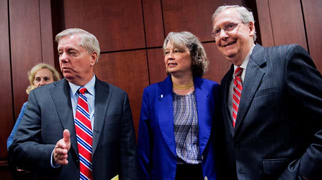 Sen. Lindsey Graham, R-S.C., left, Carol Tobias, president of the National Right to Life Committee, and Senate Minority Leader Mitch McConnell, R-Ky., talk before a news conference.