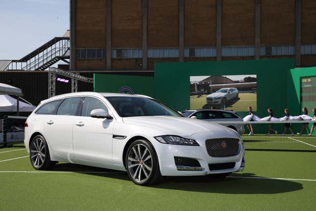 Image of a white Jaguar XF Sportbrake on a grass tennis court