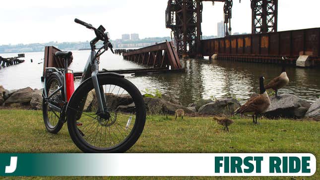 A photo of an NIU E Bike on the banks of the Hudson river. 