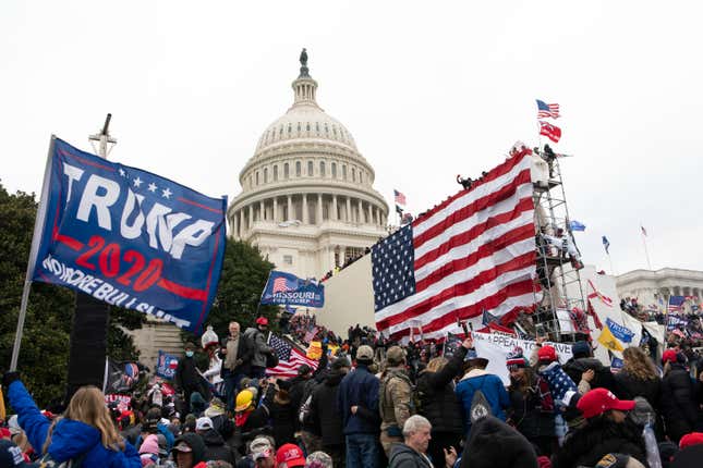 Rioters stand outside the U.S. Capitol in Washington, on Jan. 6, 2021.