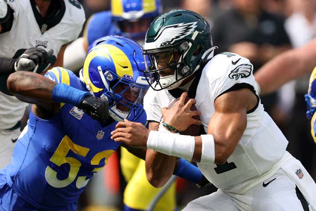 INGLEWOOD, CALIFORNIA - OCTOBER 08: Jalen Hurts #1 of the Philadelphia Eagles runs with the ball while being tackled by Ernest Jones IV #53 of the Los Angeles Rams in the first quarter at SoFi Stadium on October 08, 2023 in Inglewood, California. (Photo by Harry How/Getty Images)