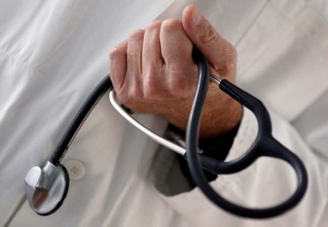 A photo illustration shows a French general practitioner holding a stethoscope in a doctor's office in Bordeaux January 7, 2015.