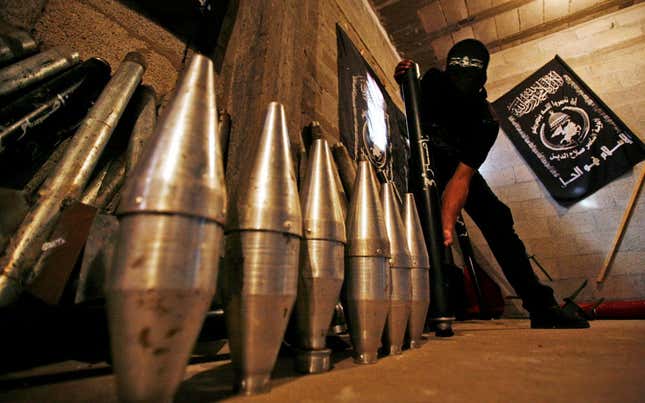 ** FILE ** In this file photo from Monday, Sept. 15, 2008, a Palestinian militant from the Al Nasser Brigades, an armed wing of the Popular Resistance Committees with ties to the Islamic group Hamas, shows the explosive tips of homemade rockets during a display at a storage facility in Gaza City. Most of the Hamas rockets targeted at Israel are thrown together in small metal shops in densely populated areas of Gaza. But a growing number are more sophisticated, longer-range weapons, believed put together from parts thought to originate in Syria or Iran, and smuggled in through Egyptian tunnels. Despite that new capacity, Hamas is still far beyond another anti-Israeli militant group, Hezbollah, in its rocket capabilities.